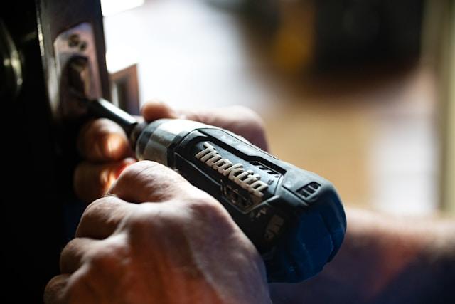 Glow Handyman technician fixing a stubborn home repair issue.